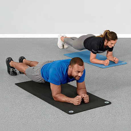 Man and woman doing core bridges on premium quality black and blue foam exercise mats by Perform Better