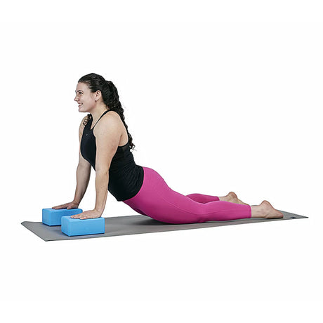 Woman stretching with blue foam yoga block pair by Perform Better